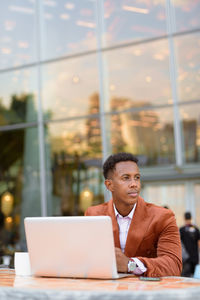 Businessman looking away while sitting at cafe