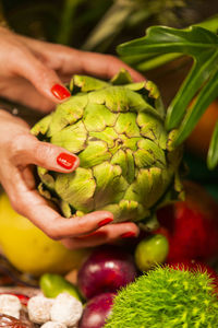 Close-up of woman hand holding fruit