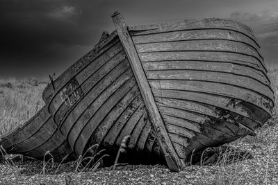 Abandoned structure on field against sky