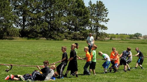 Boys playing soccer on field