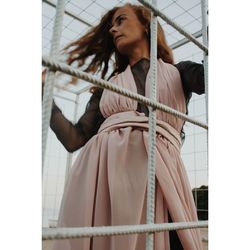 Low angle view of young woman standing by rebars