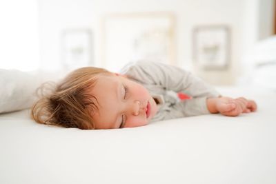 Close-up of baby lying at home