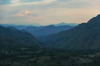 Scenic view of mountains against cloudy sky