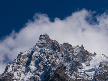 Low angle view of mountain against cloudy sky