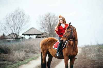 Person riding horse on field