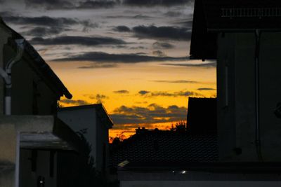 Built structures against sky at sunset