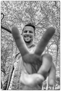 Portrait of happy man with arms raised