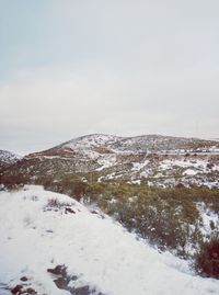 Scenic view of mountains against sky during winter