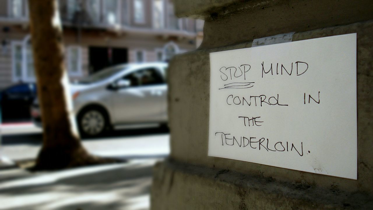 text, western script, transportation, communication, focus on foreground, mode of transport, car, land vehicle, close-up, selective focus, no people, day, building exterior, street, outdoors, built structure, sign, architecture, sunlight, city