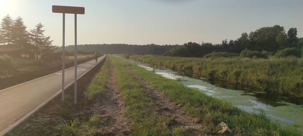 Road amidst field against sky