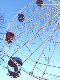 Low angle view of ferris wheel against blue sky