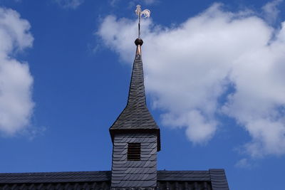 Low angle view of building against cloudy sky