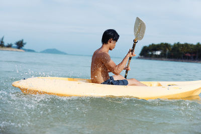 Rear view of man swimming in lake