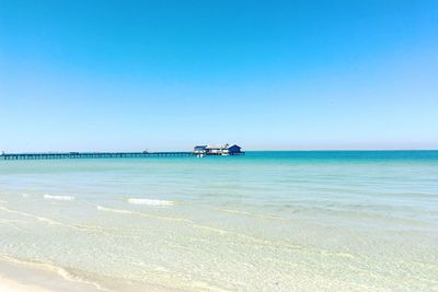 Scenic view of sea against clear blue sky