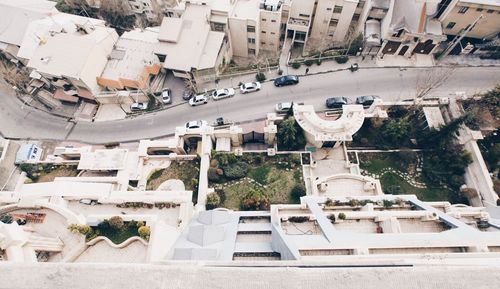 Elevated view of cars on road by buildings