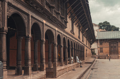 Exterior of old building in town against sky