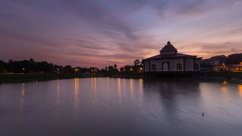 Reflection of buildings in water at sunset