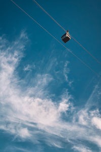 Low angle view of helicopter flying against sky