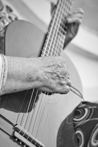 Cropped image of person playing guitar