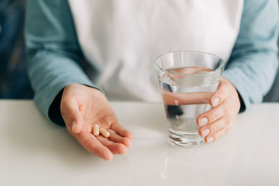 Midsection of man holding drink