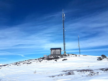 Snow covered mountain against blue sky