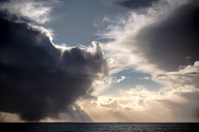 Scenic view of sea against storm clouds