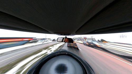Close-up of cars moving on highway