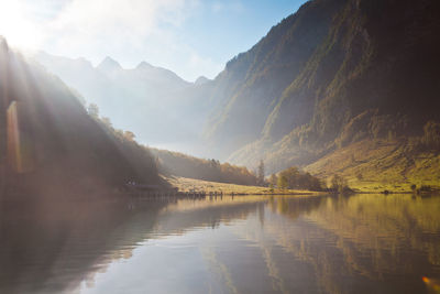 Scenic view of lake by mountains against sky