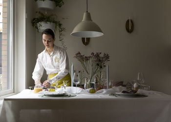 Woman preparing place settings