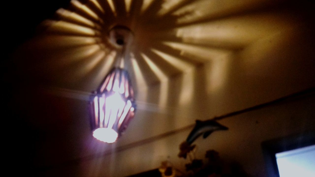 LOW ANGLE VIEW OF ILLUMINATED LIGHTS AT HOME