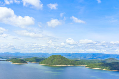 Scenic view of sea and mountains against sky