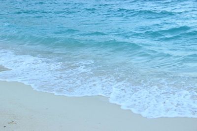 High angle view of waves rushing towards shore