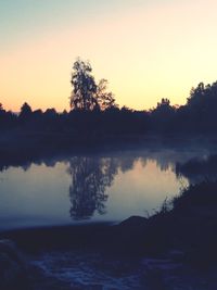 Scenic view of lake at sunset