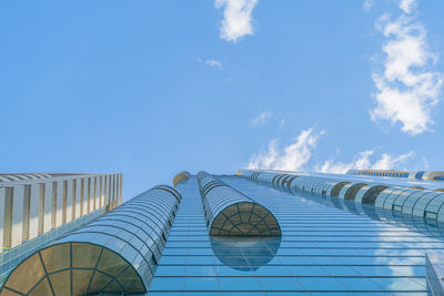 Low angle view of modern building against blue sky