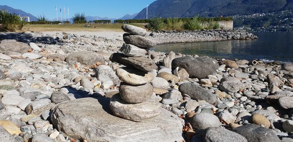 Rocks on shore by lake