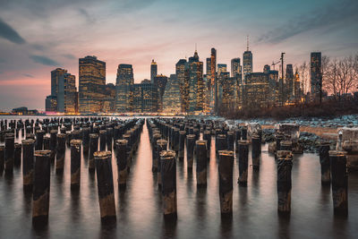 Panoramic view of wooden posts and buildings against sky