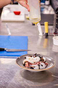 Cropped hand of person preparing food