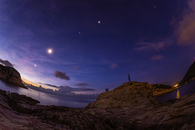 Scenic view of mountains against sky at night