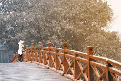 People walking on wooden bridge in winter