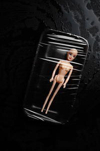 High angle view of doll packed in container