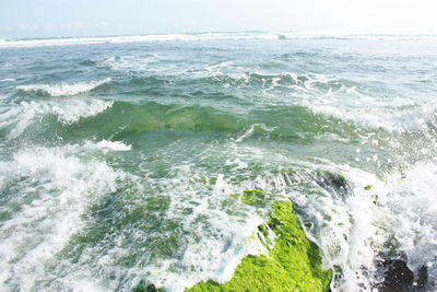 Scenic view of sea waves splashing on shore