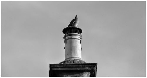 Low angle view of lighthouse against building