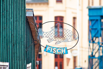 Low angle view of sign on green wall