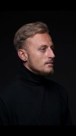 Portrait of young man with piercings