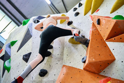 Woman training at bouldering gym. active recreation, sports exercises