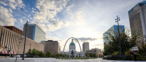 Buildings in city against cloudy sky