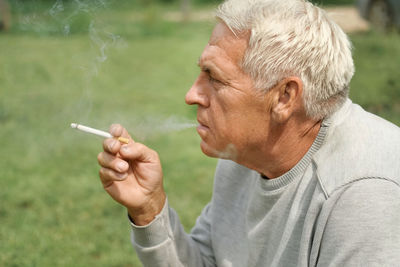 Close-up of man smoking cigarette