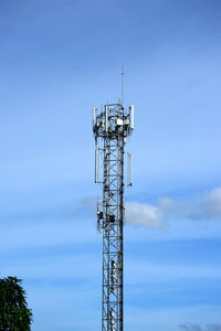 Low angle view of electricity pylon against clear blue sky