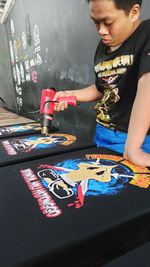 Boy playing with text on table