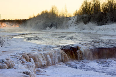 Scenic view of snow covered landscape during sunset